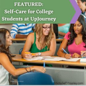 Three female-presenting young adults sitting around a table in a lecture hall.  They appear to be highlighting and taking notes from papers on their tabletop.  