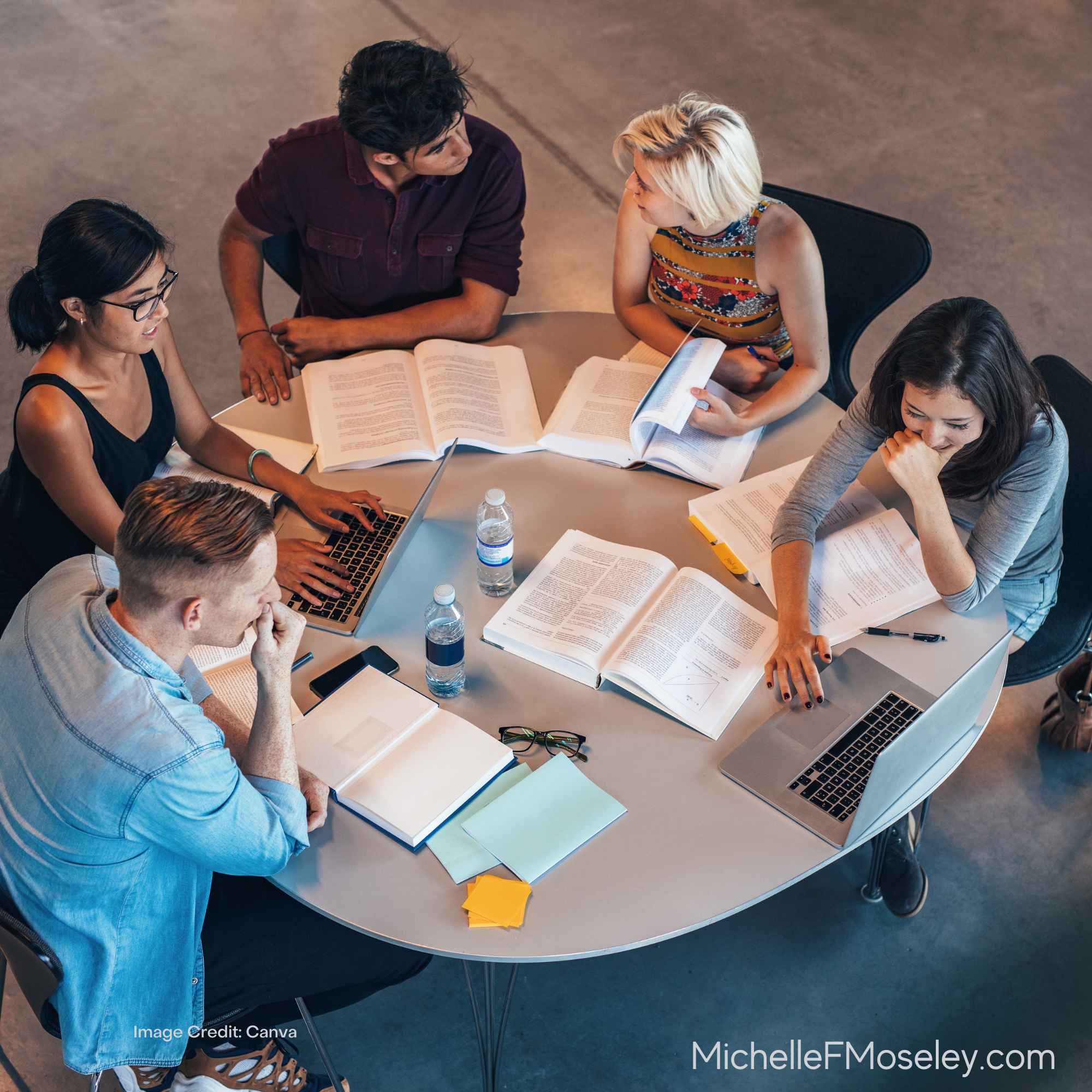 Group of peeople around a table, learning more about mental health through a workshop or seminar.