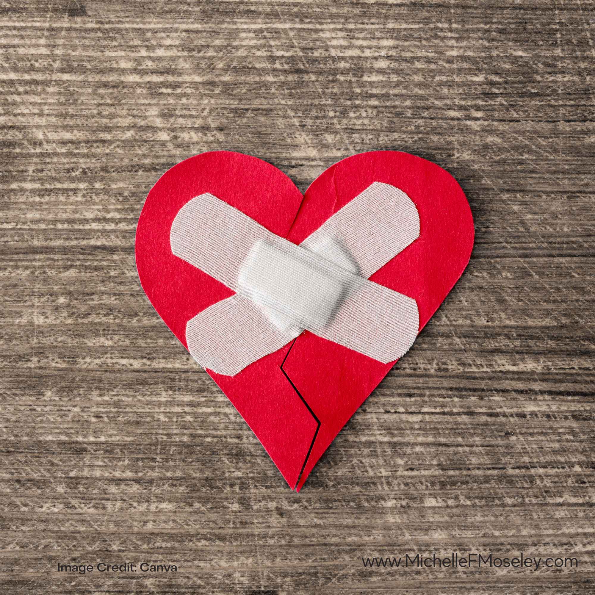 Red felt heart with bandages placed across the center to represent healing after religious trauma.