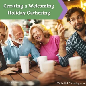 A man with white hair and beard, a women with blonde hair, and a man with brown hair and beard are gathered around a table and laughing with one another at a welcoming holiday gathering.  